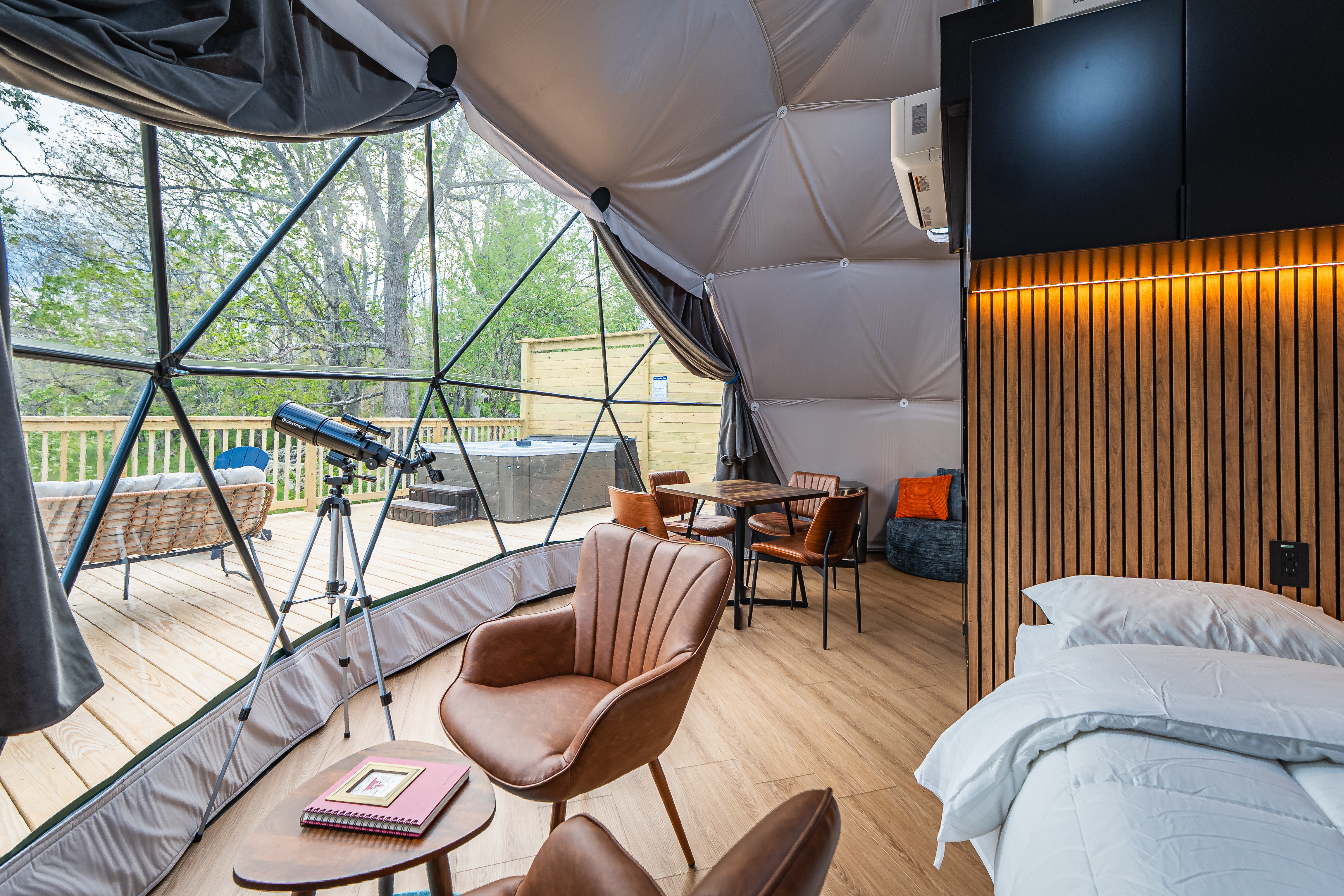 Dome interior with telescope and hot tub view